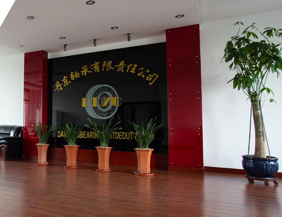 Reception hall with the Dandong Bearing name and logo on the wall